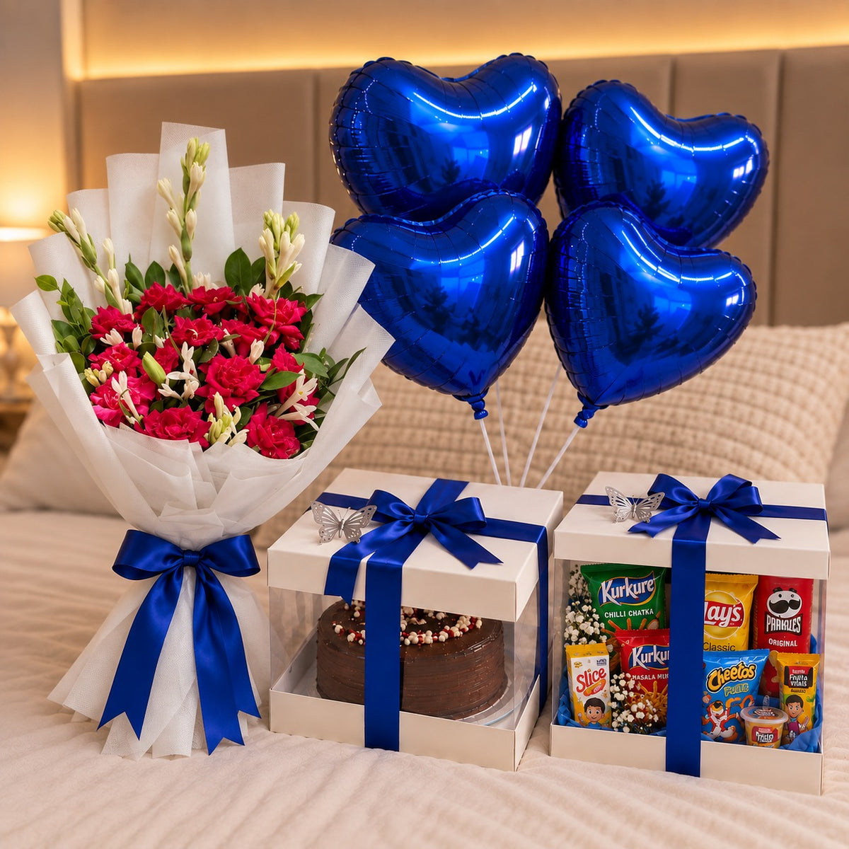 Birthday hamper with chocolate cake, snacks box, flower bouquet and blue heart balloons